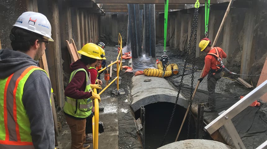 pipe installation with people in hard hats
