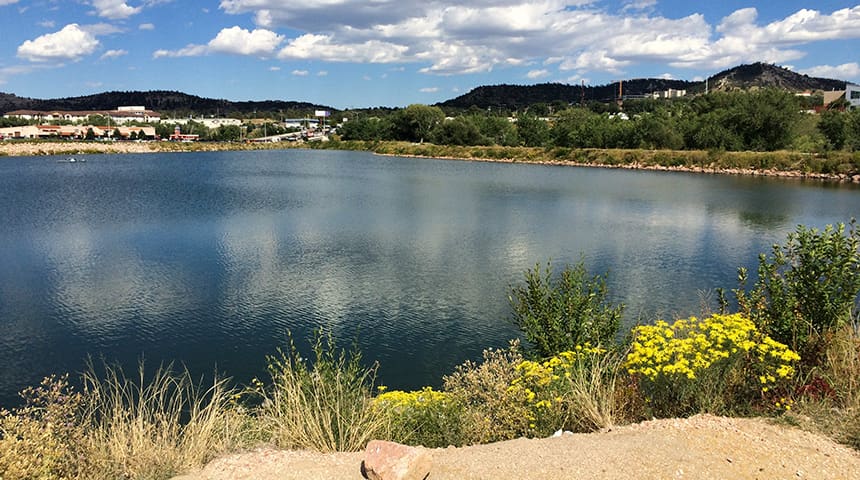 Water reservoir with sky and buildings