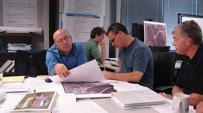 engineers looking at plans in a conference room