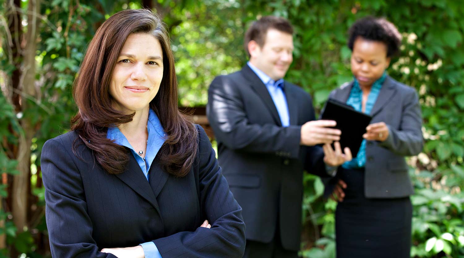 three professionals standing outside