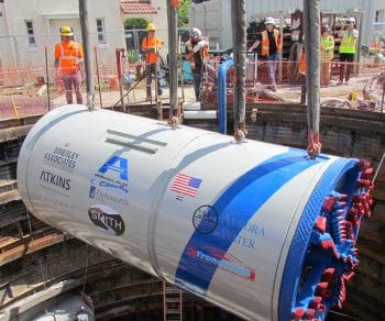 construction team lowering tunnel boring machine