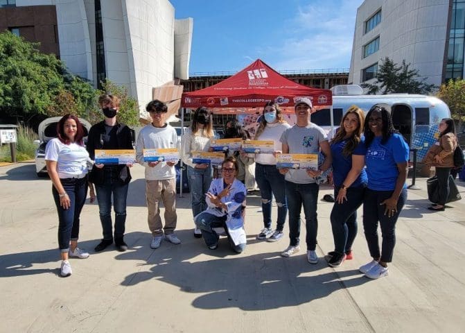Carollo Cares volunteers presenting awards to young engineers at a STEM event.