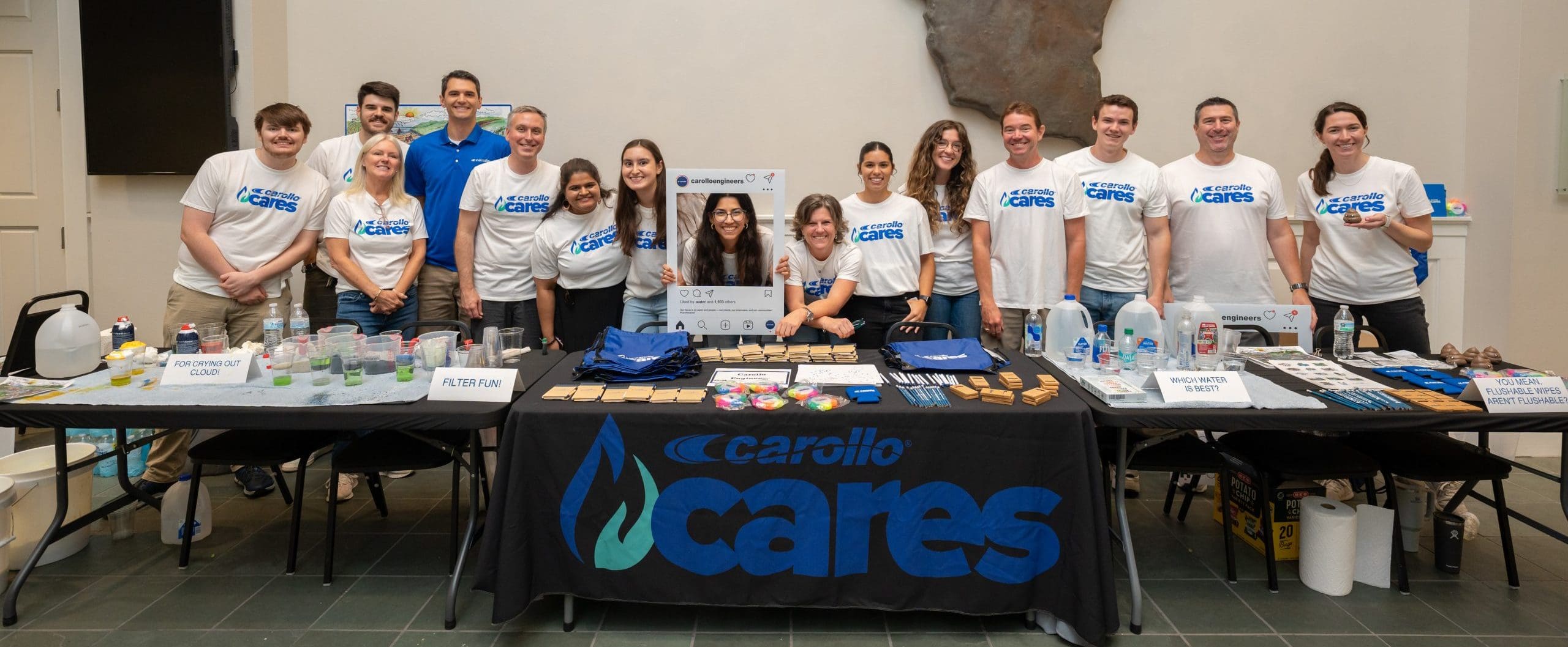 several Carollo Cares volunteers standing behind a long table at a STEM event in Baylor, Texas.