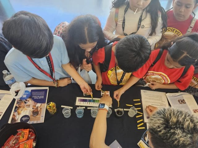 Children participating in a water experiment at a Carollo Cares event.