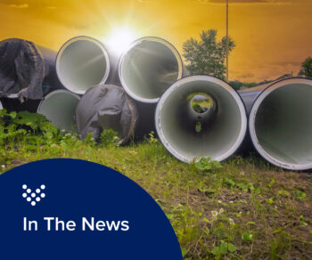 Photo of sewer pipes stacked in front of a sunset. representing Carollo work with smart sewer technology.